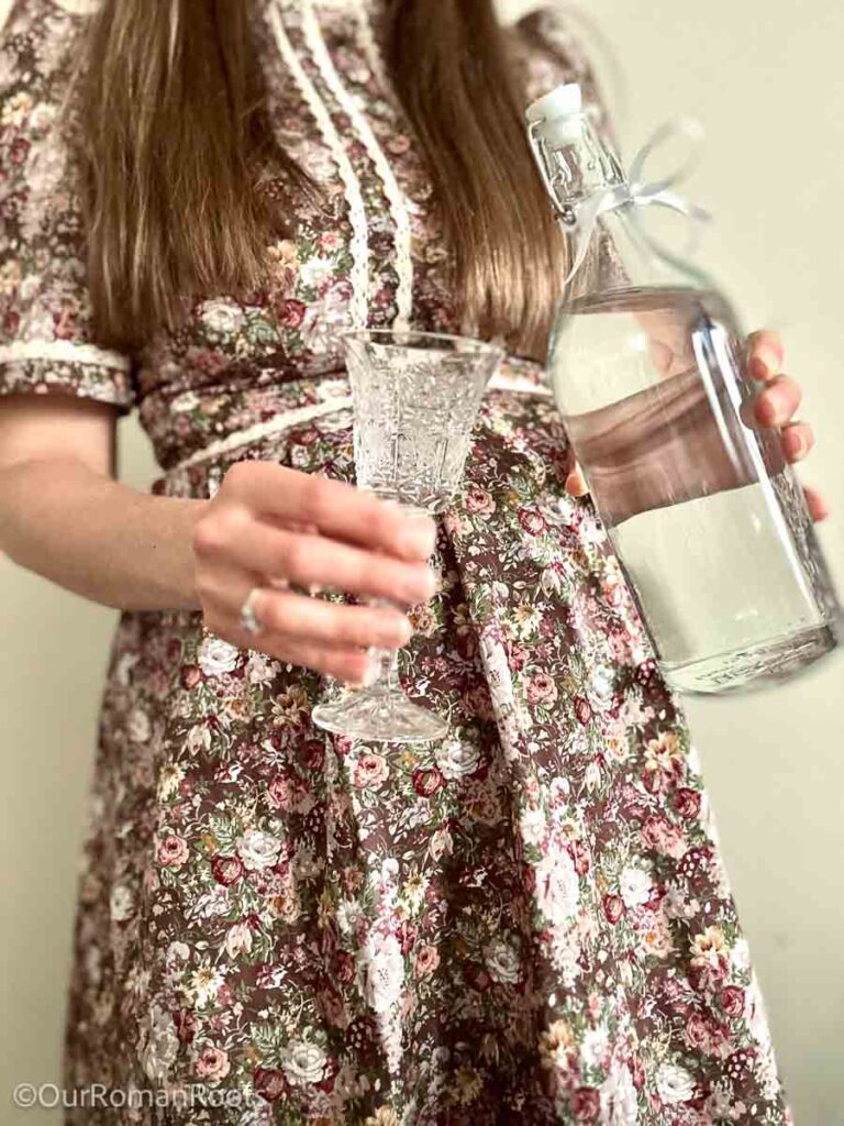 Pouring a small glass of St. Torelli water